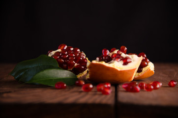 the pomegranate is ripe. cut into pieces of ripe pomegranate. on wooden boards.