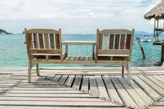 deck chairs on a terrace beach, looking out towards the horizon.