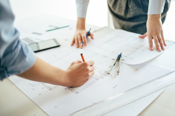 Close up of architects hands working on project