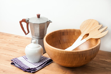 Wooden bowl and cutlery with an Espresso maker on wooden background or table. Natural serving table setting