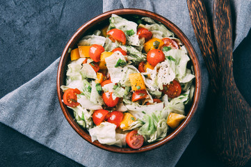 The coleslaw and tomatoes on the table. The dark style