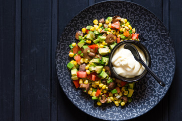 Salad with avocado tomato corn mushrooms and mayonnaise