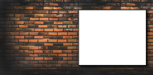 Blank billboard attached to a buildings exterior brick wall.