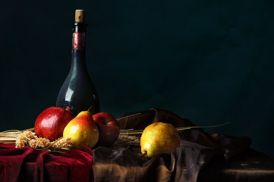 A bottle of old wine and ripe fruit on a dark background, Dutch still life.