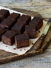 pieces of cake chocolate brownies on wooden background. selective focus.