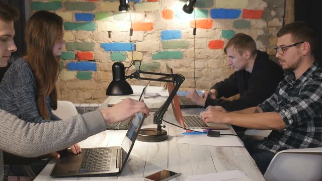 Workers finish work on laptops in the office