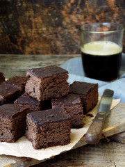 pieces of cake chocolate brownies on wooden background. selective focus.