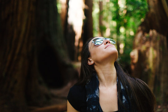 20-something female enjoys a walk through redwood park