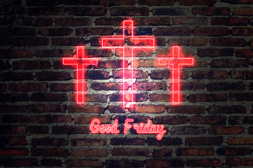 Good Friday. red neon Three crosses glowing on grunge brick background  