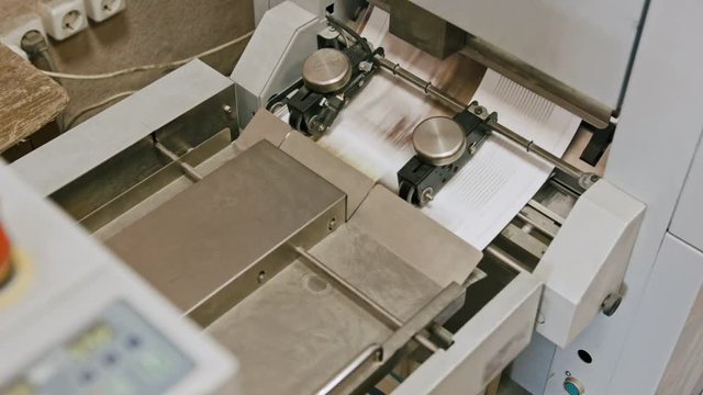 Folding machine on printing polygraph industry - red button and conveyer, slider shot
