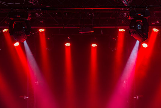 The ceiling of the concert stage with red and white spotlights on the stage farm