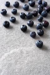 Blueberries in crystal bowl on gray stone
