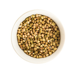 Green buckwheat in a bowl isolated on a white background. Top view.