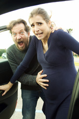 Couple screaming looking camera with baby coming contractions have started