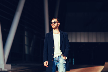 portrait of a handsome man wearing jacket and sunglasses