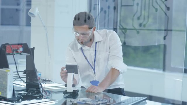  Electronic engineer working in the lab, testing 3D printer & circuit boards