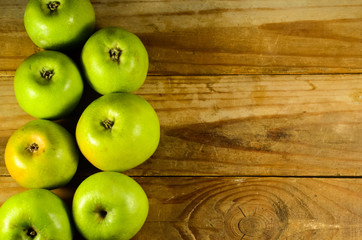 Green apples on a wooden table