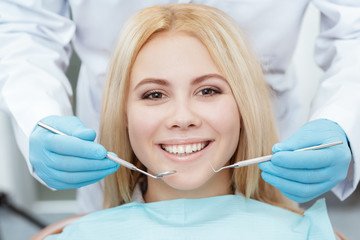 Confident smile. Cropped closeup of a gorgeous young blonde woman smiling to the camera at the dentist