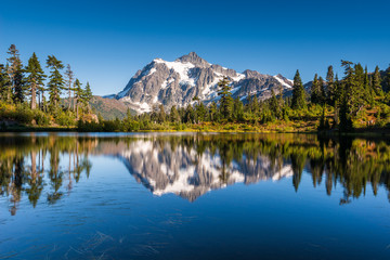 Mt Shuksan in North Cascades National Park reflects in Picture Lake which is on the slopes of the adjacent Mount Baker
