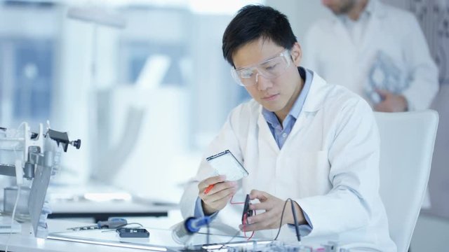  Portrait serious electronics engineer working in the lab