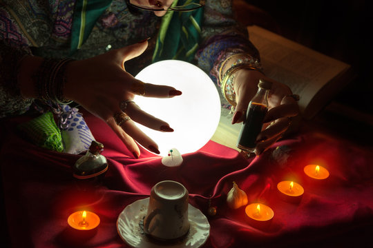 Love potion in hand of fortune teller woman