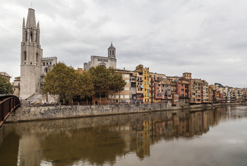 Fototapeta na wymiar City view, colored houses over river, autumn day, Girona, Catalonia,Spain.