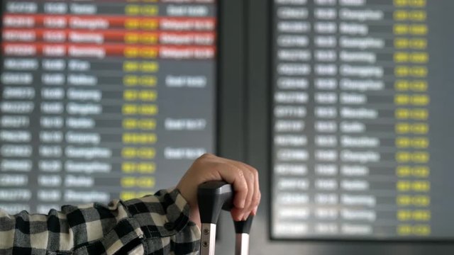 reading mobile phone in airport, waiting for boarding