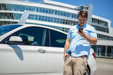 man with the phone near the car