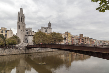 Fototapeta na wymiar City view, colored houses over river, autumn day, Girona, Catalonia,Spain.
