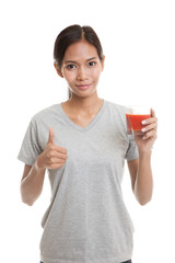 Young Asian woman thumbs up with tomato juice.