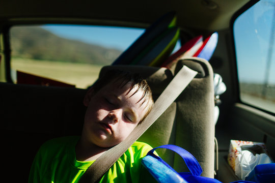 8 year old boy sleeps in back of car