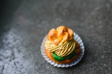 Delicious profiteroles with paste and basil. Finger food. Selective focus