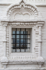 Window with bars in the Orthodox Church of white washed brick. Space to insert text