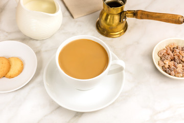 Cup of coffee with milk, butter cookie and milk jar