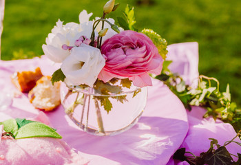 The vase with flowers  stands on the table