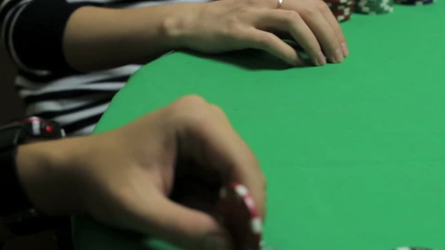 Poker players sitting at a green table