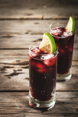 Traditional Spanish alcoholic drink, cocktail, Calimocho. With wine, cola, lime juice and ice. Decorated with pieces of lime. Copy space