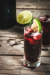 Traditional Spanish alcoholic drink, cocktail, Calimocho. With wine, cola, lime juice and ice. Decorated with pieces of lime. Copy space 