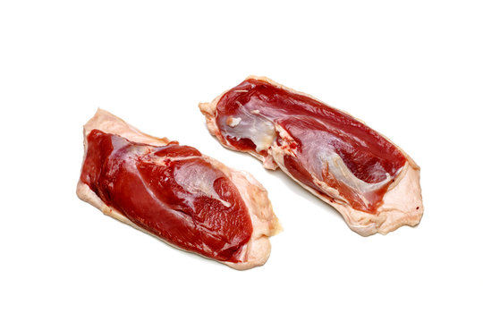 Raw duck breast lying on a white background, not isolated, with a shadow.