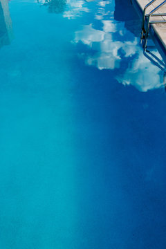 Reflection of blue sky in pool water