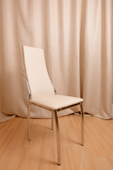 Contemporary chair standing in front of curtains background