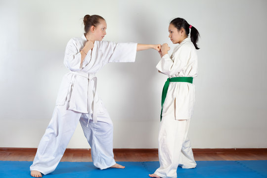 Two girls demonstrate martial arts working together