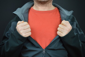 man showing his red t-shirt under a black jacket with empty space for a message 