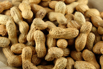 Peanuts in a wooden bowl - close-up.