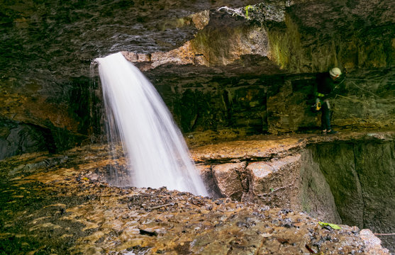 Speleologist sets route at Mayei Cave entrance Ecuador highlighting the thrill of cave exploration and the beauty of subterranean adventure