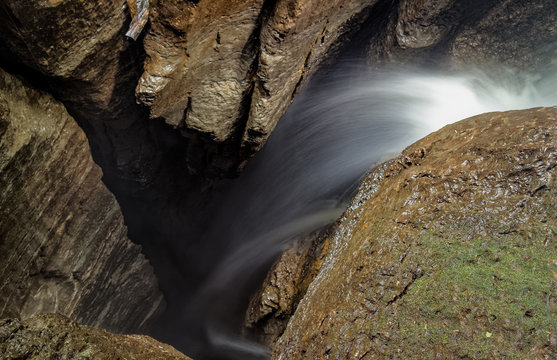 Discover the breathtaking 75m deep waterfall entrance shaft at Mayei Cave in Ecuadorian Amazonia through stunning long exposure photography.