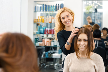 So what are we going for? Cheerful hairdresser working with her client at the beauty salon