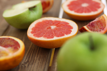 Mix of fresh sliced fruits on a wooden background. Photo with depth of field.