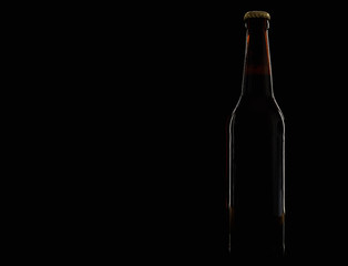 A bottle of beer on a black background