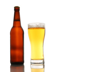 Bottle and a glass of beer with foam isolated on white background